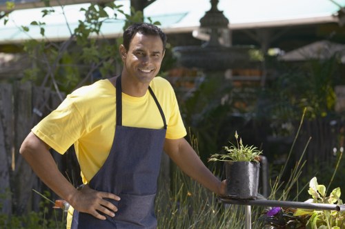 Trained gardener using PPE during outdoor maintenance in Turnpike Lane